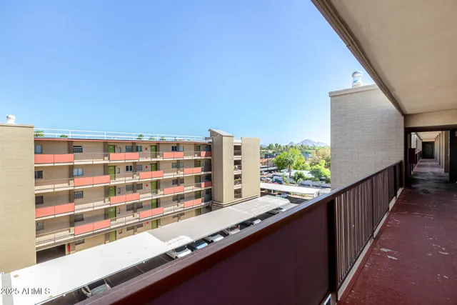 a view of balcony with wooden floor and fence