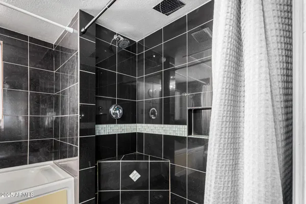 a bathroom with a shower and a sink