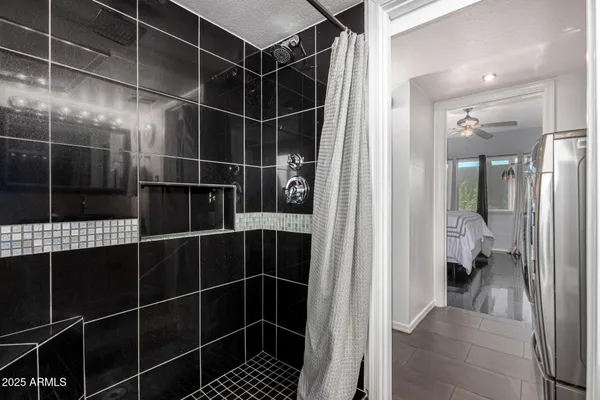 a bathroom with a glass shower door