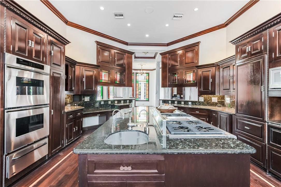 5550 Hancock Road Southwest Ranches, FL 33330 - Photo 14 of 60 a kitchen with stainless steel appliances granite countertop a stove and a sink