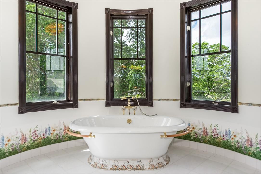 5550 Hancock Road Southwest Ranches, FL 33330 - Photo 46 of 60 a white bath tub sitting in a bathroom next to a window