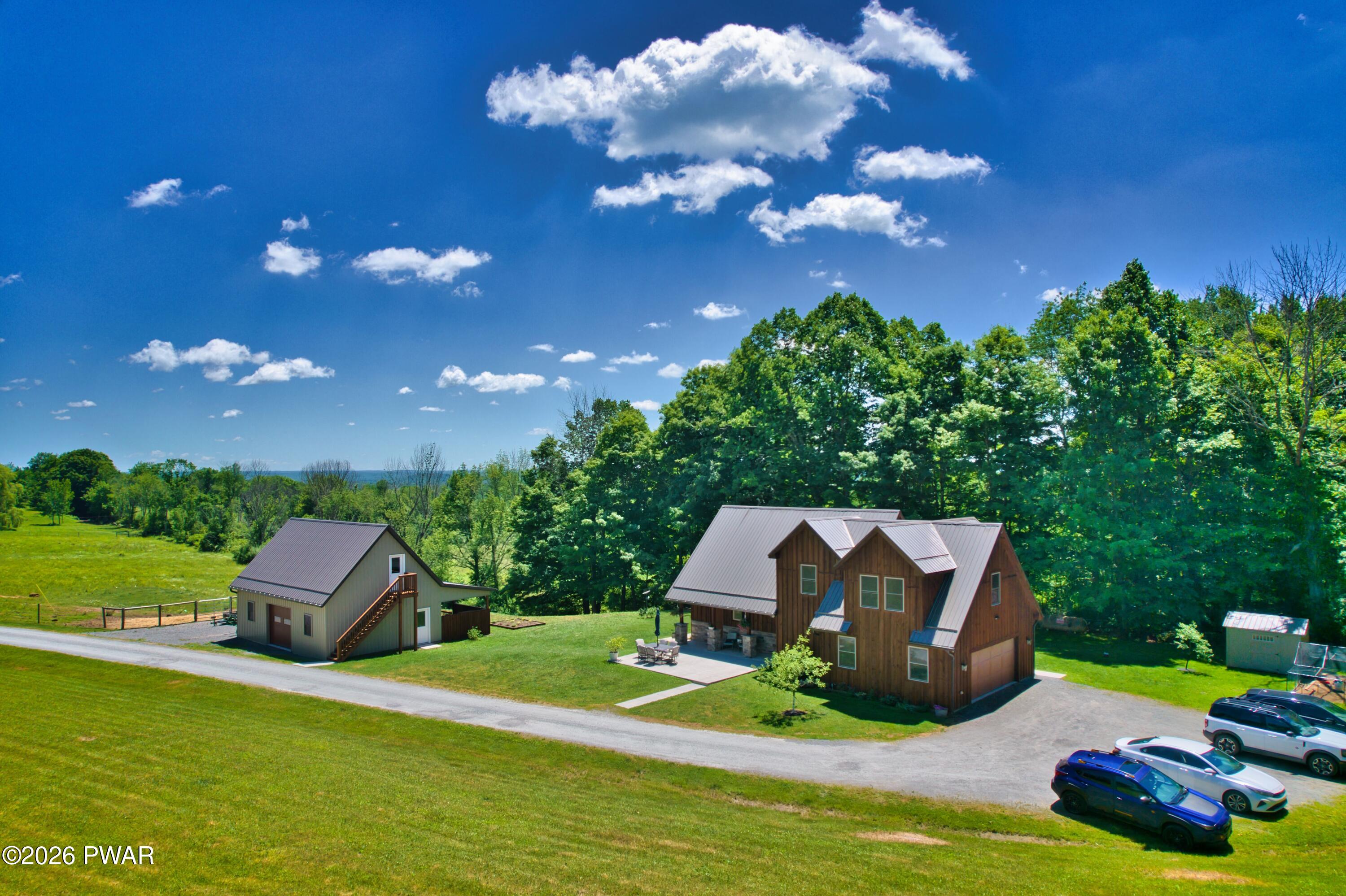 149 Sheards Road Milanville, PA 18443 - Photo 12 of 57 a front view of a house with garden