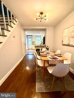 a dining room with wooden floor and breakfast area