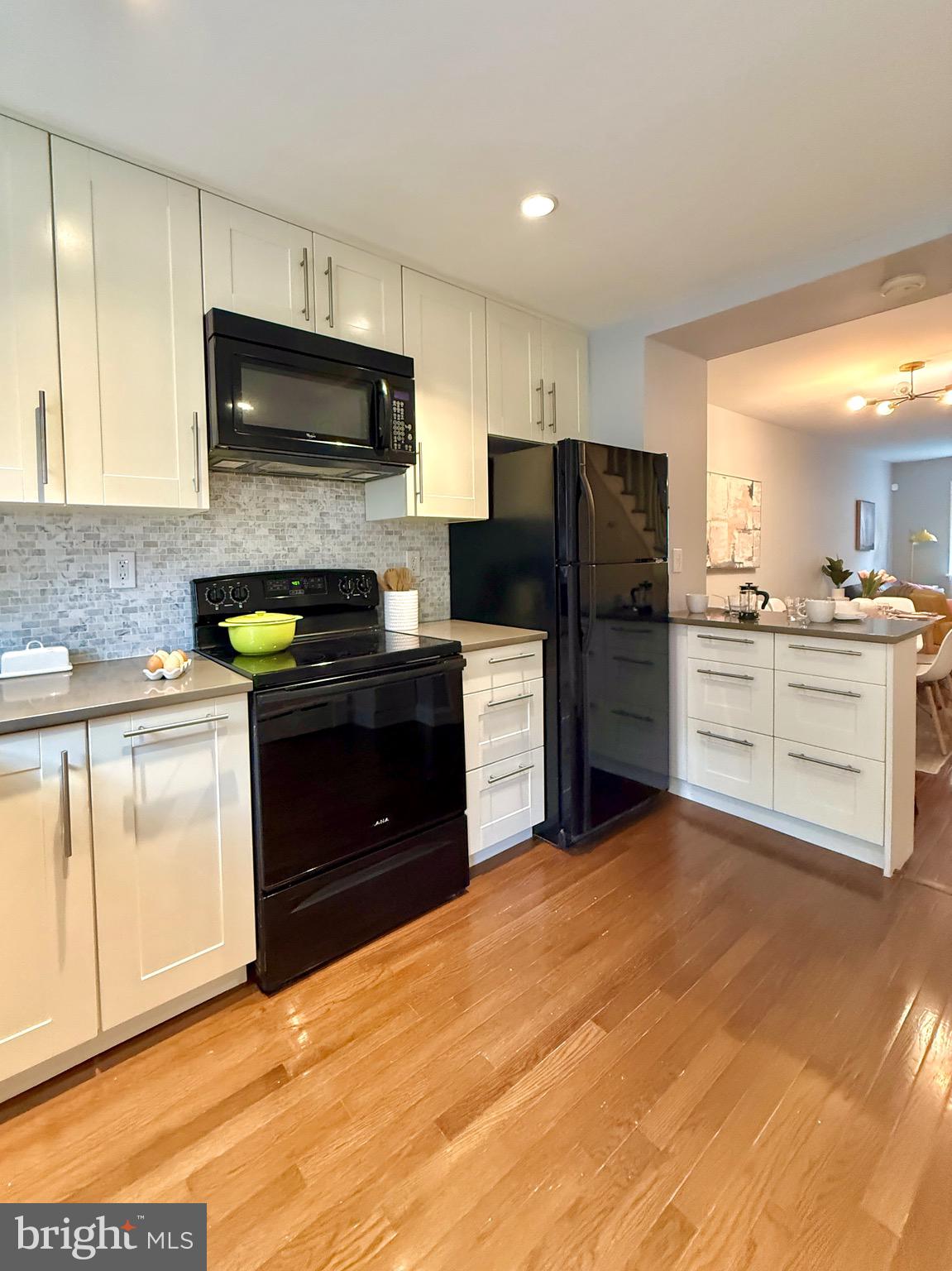 619 Sears Street Philadelphia, PA 19147 - Photo 7 of 23 a kitchen with granite countertop a stove top oven and refrigerator