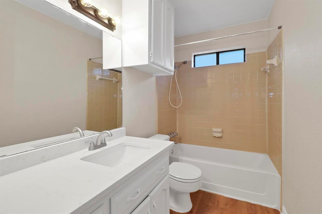 6632 Valley View Drive Watauga, TX 76148 - Photo 16 of 18 a bathroom with a sink a toilet and shower