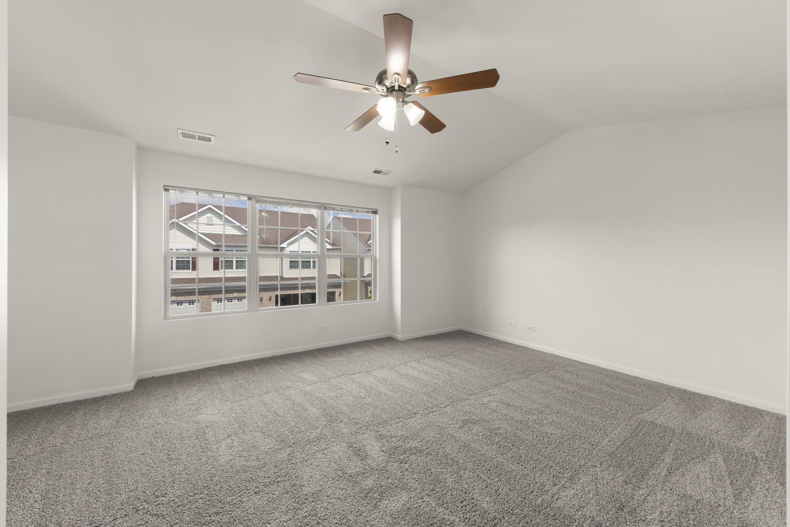 1034 Turin Drive Hampshire, IL 60140 - Photo 12 of 23 an empty room with fan and windows