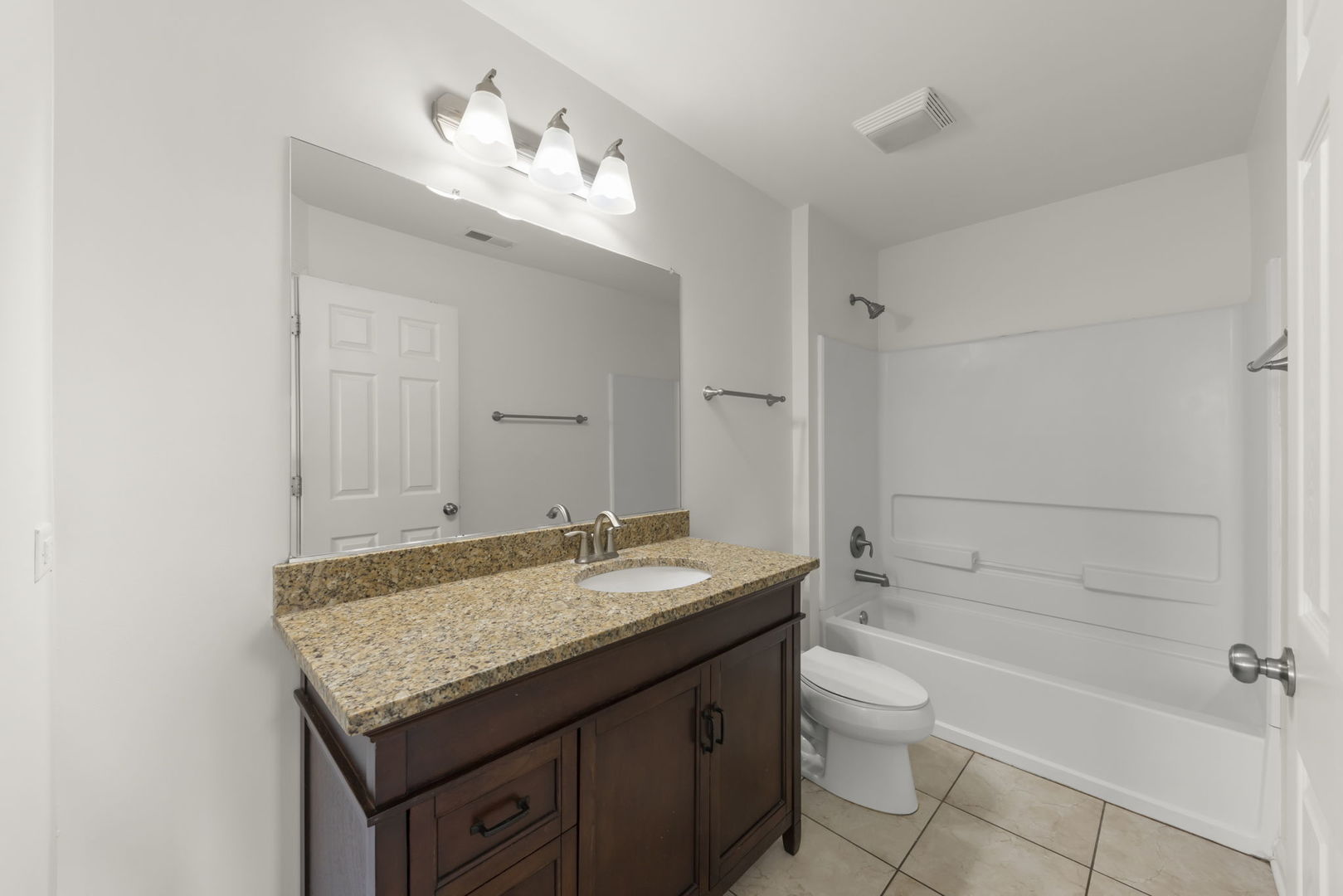 1034 Turin Drive Hampshire, IL 60140 - Photo 17 of 23 a bathroom with a granite countertop sink a toilet and bathtub