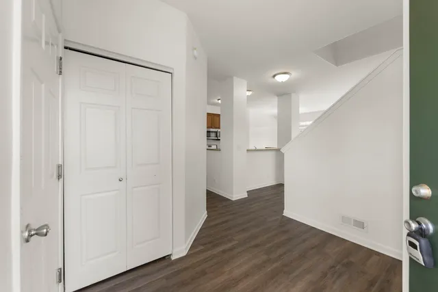 a view of a hallway with wooden floor