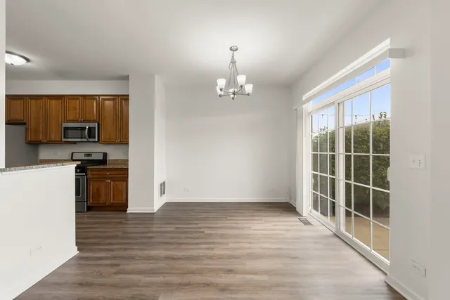 a view of a kitchen with wooden floor and electronic appliances