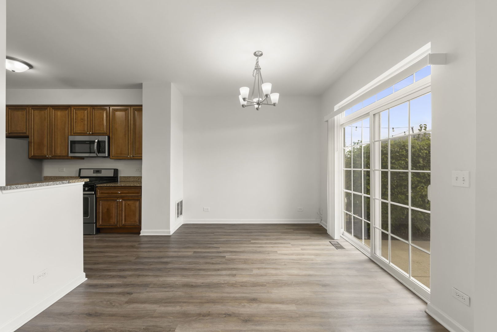 1034 Turin Drive Hampshire, IL 60140 - Photo 6 of 23 a view of a kitchen with wooden floor and electronic appliances