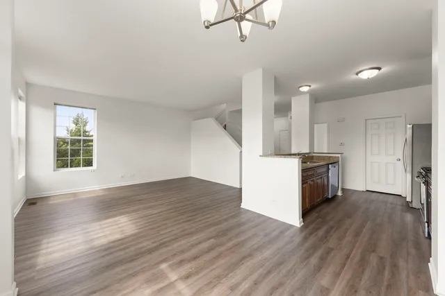 a view of a kitchen with a sink and dishwasher wooden floor