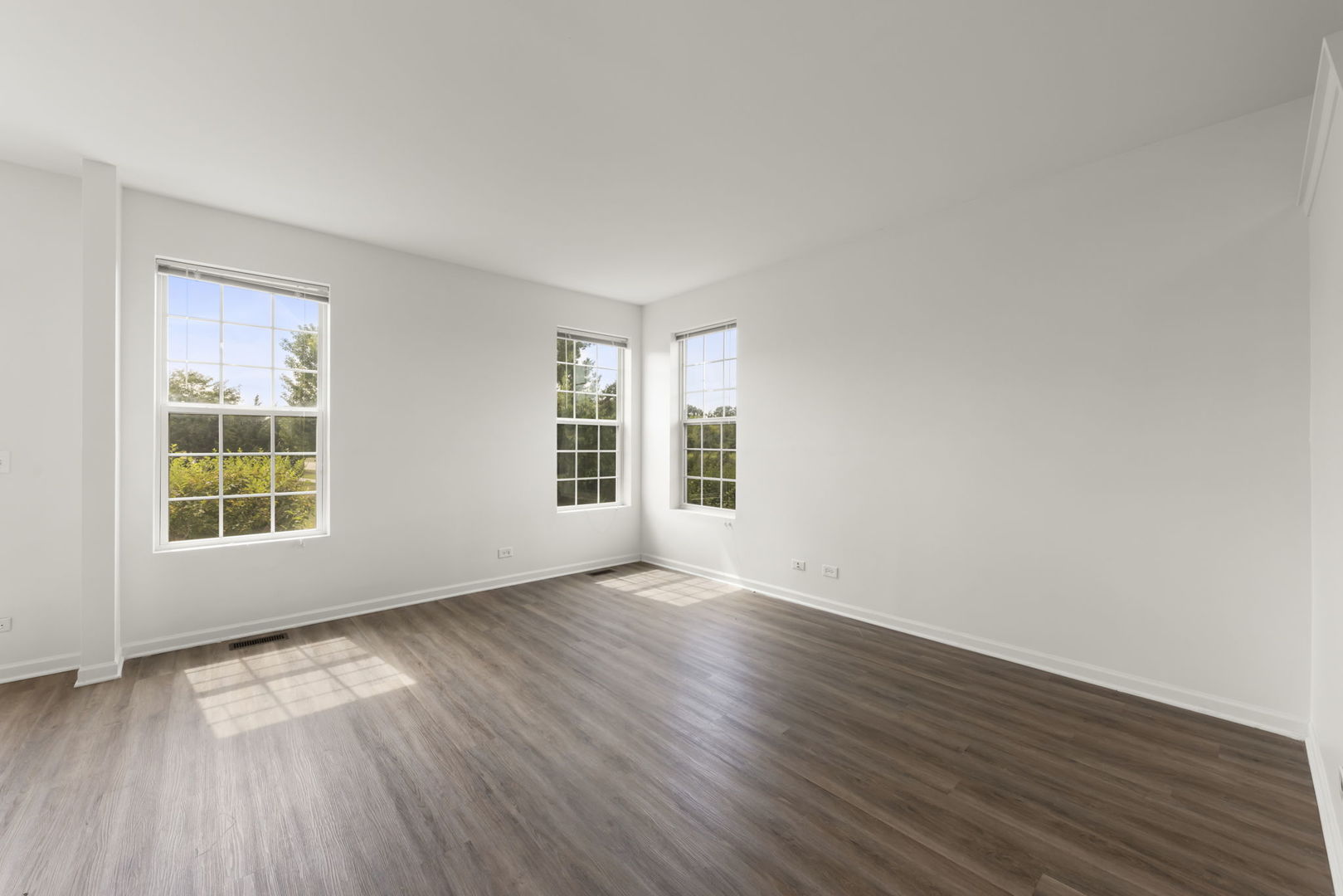 1034 Turin Drive Hampshire, IL 60140 - Photo 8 of 23 an empty room with wooden floor and windows
