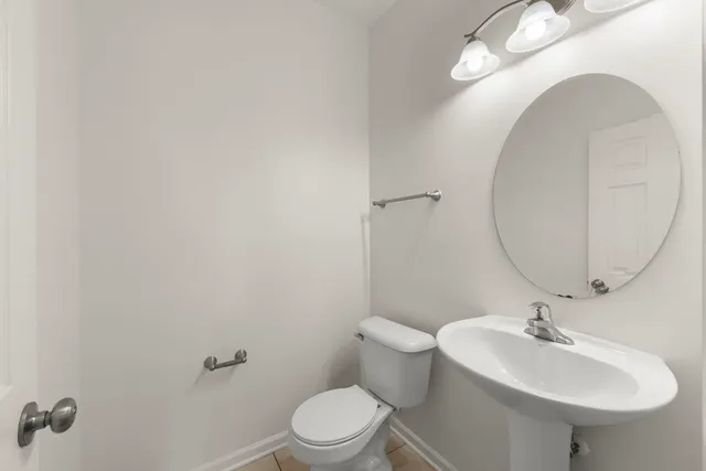 a bathroom with a sink toilet and a mirror