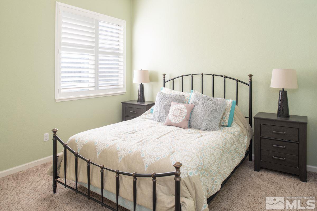 1725 Colavita Way Reno, NV 89521 - Photo 15 of 22 a bedroom with a bed a lamp and a window