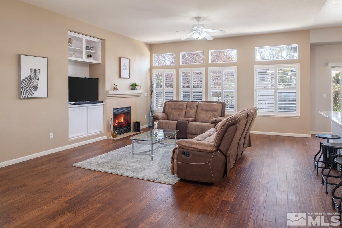 1725 Colavita Way Reno, NV 89521 - Photo 6 of 22 a living room with furniture a flat screen tv and a fireplace
