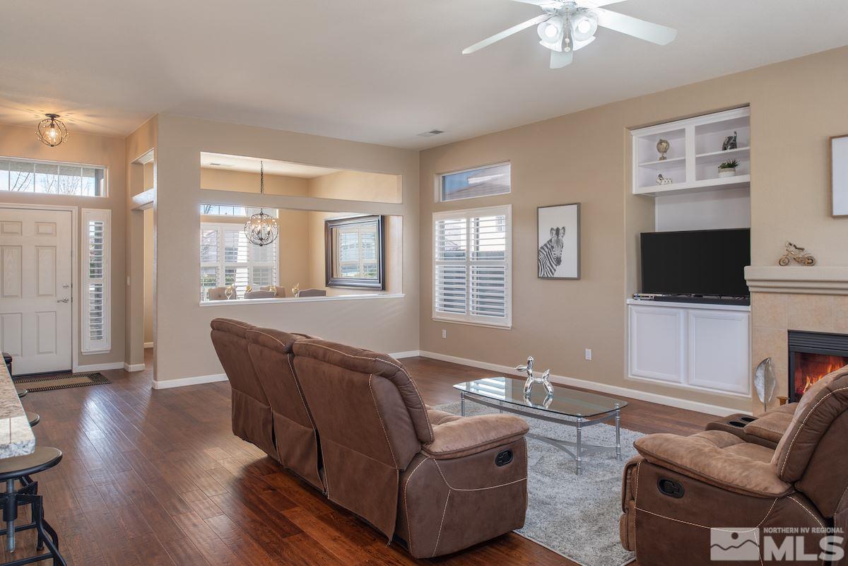 1725 Colavita Way Reno, NV 89521 - Photo 8 of 22 a living room with furniture fireplace and a flat screen tv