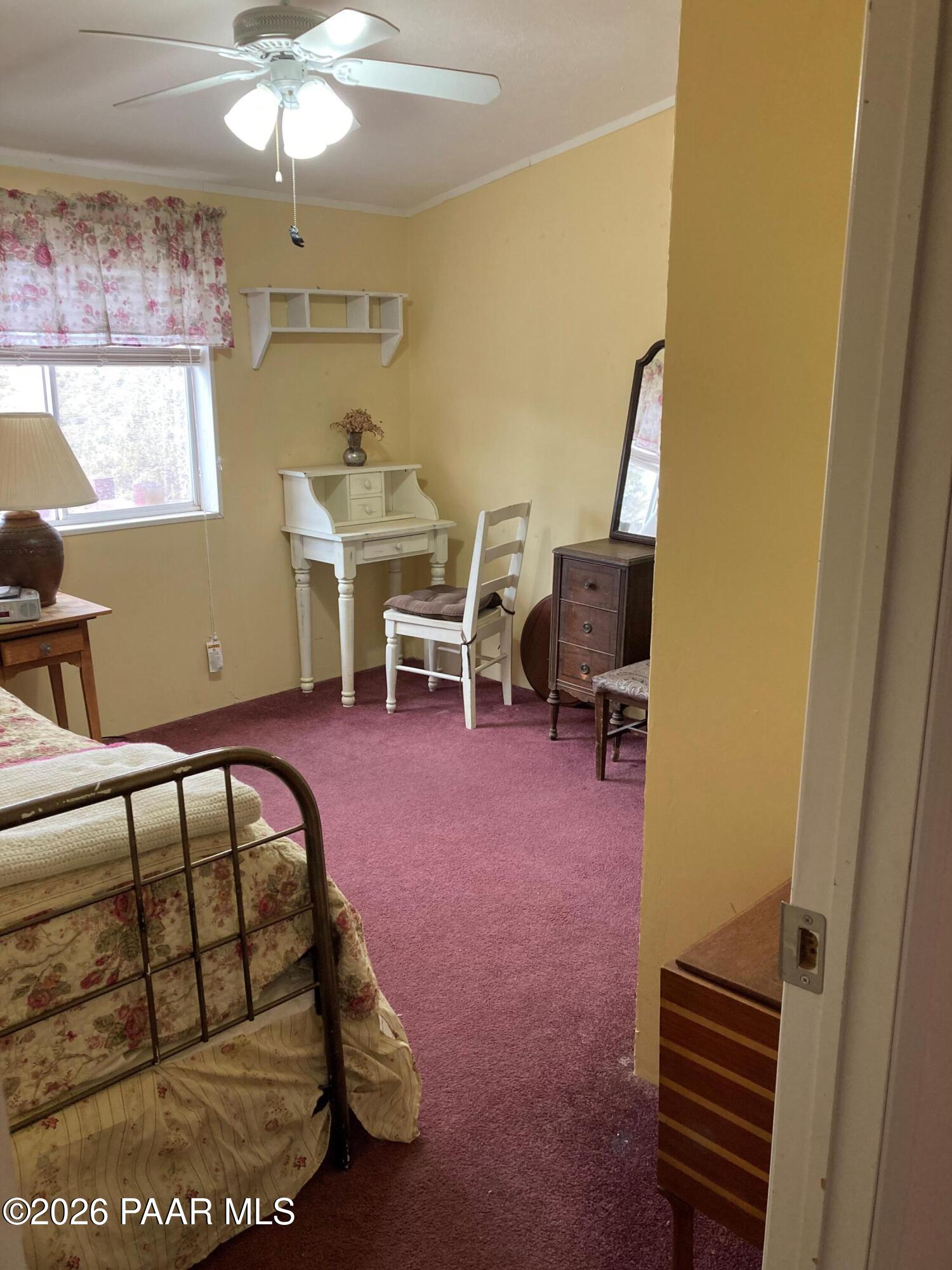 2373 Roberts Road Ash Fork, AZ 86320 - Photo 13 of 41 a view of a bedroom with furniture window and wooden floor