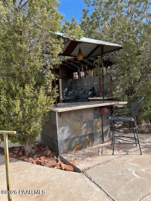 2373 Roberts Road Ash Fork, AZ 86320 - Photo 20 of 41 a patio with table and chairs under an umbrella