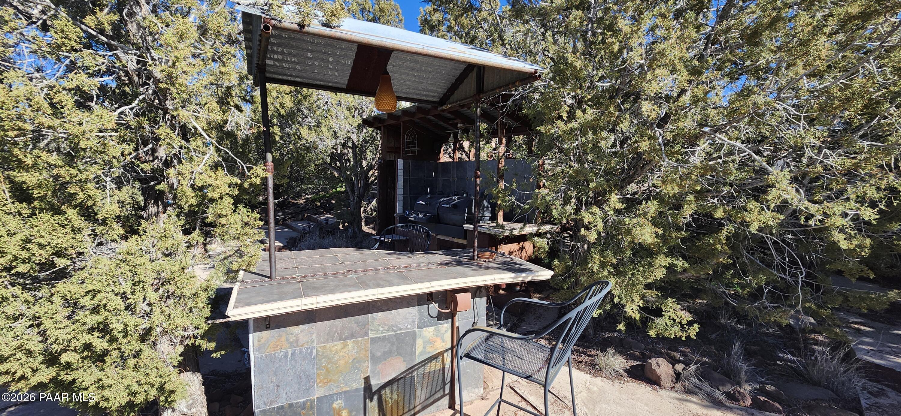 2373 Roberts Road Ash Fork, AZ 86320 - Photo 21 of 41 a view of patio with table and chairs under an umbrella