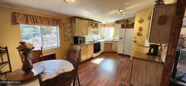 a view of a bedroom with furniture window and wooden floor