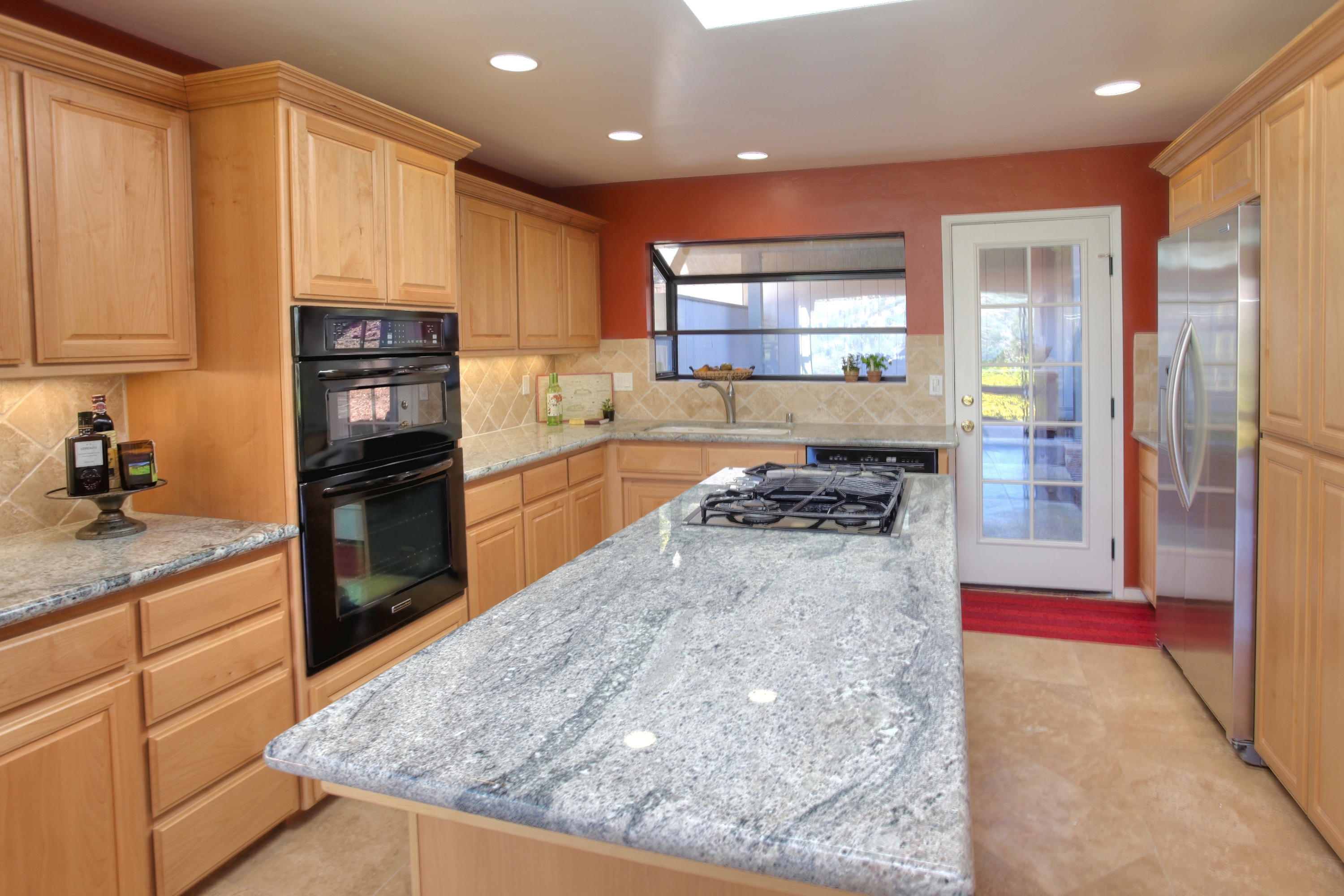 1202 Las Alturas Road Santa Barbara, CA 93103 - Photo 6 of 17 a kitchen with stainless steel appliances granite countertop a refrigerator and a stove