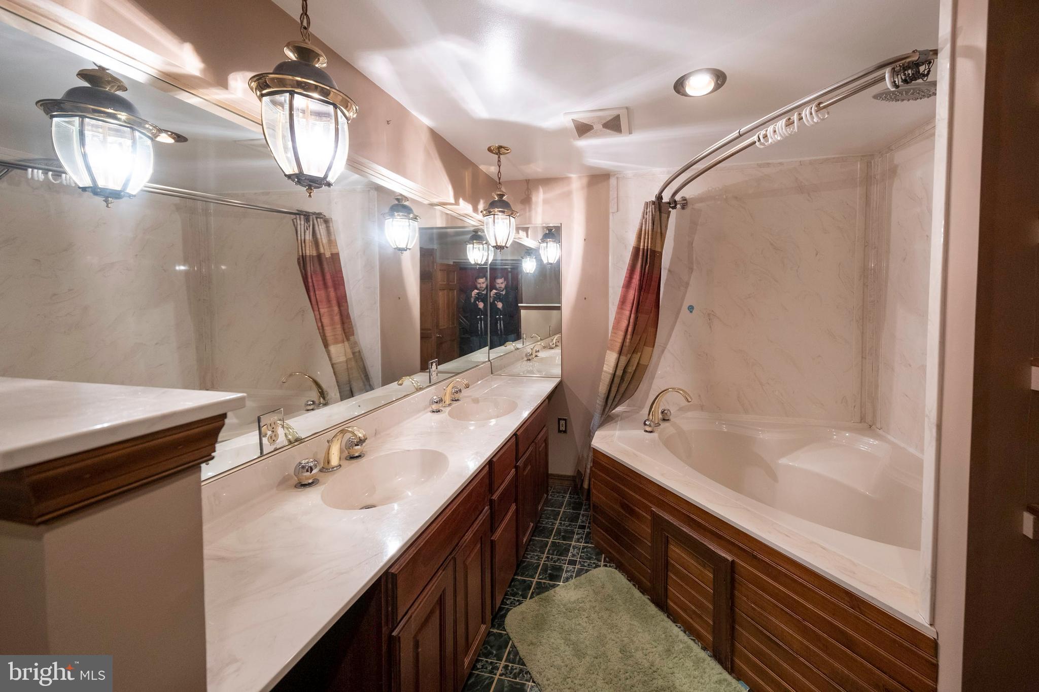 333 Sunset Road Reading, PA 19611 - Photo 11 of 17 a bathroom with a tub sink and mirror