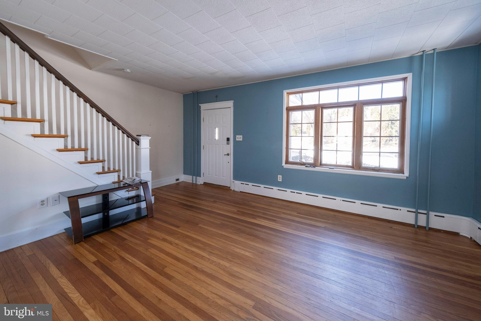 333 Sunset Road Reading, PA 19611 - Photo 3 of 17 a view of an empty room with wooden floor and a window