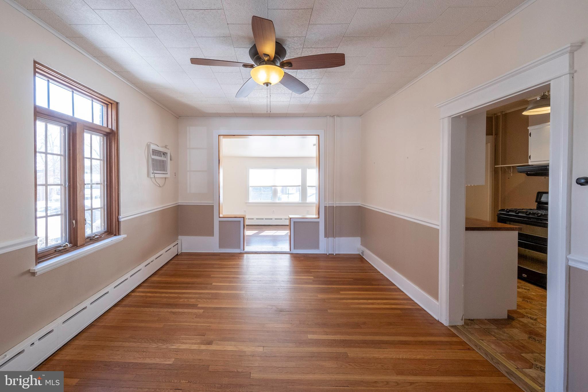 333 Sunset Road Reading, PA 19611 - Photo 4 of 17 a view of an empty room with a window and wooden floor