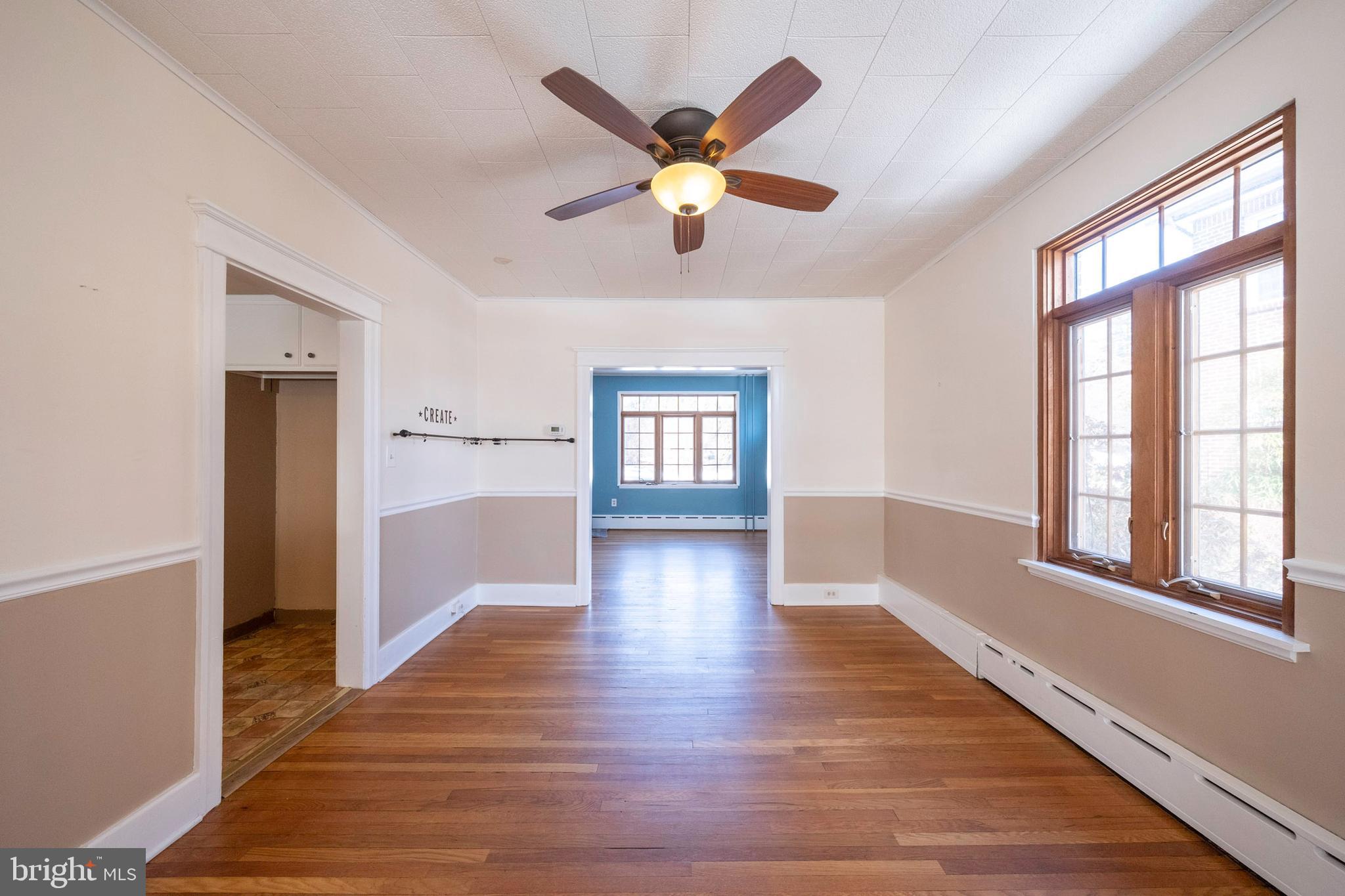 333 Sunset Road Reading, PA 19611 - Photo 8 of 17 a view of an empty room with window and wooden floor