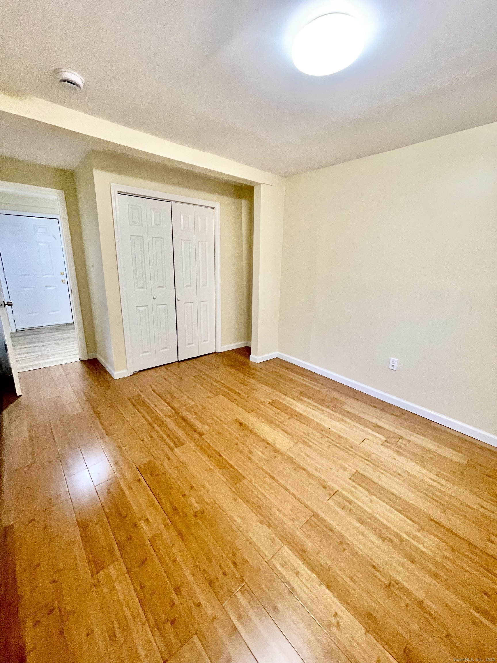 92 West Main Street, Unit 4 Vernon, CT 06066 - Photo 8 of 10 a view of empty room with wooden floor and fan