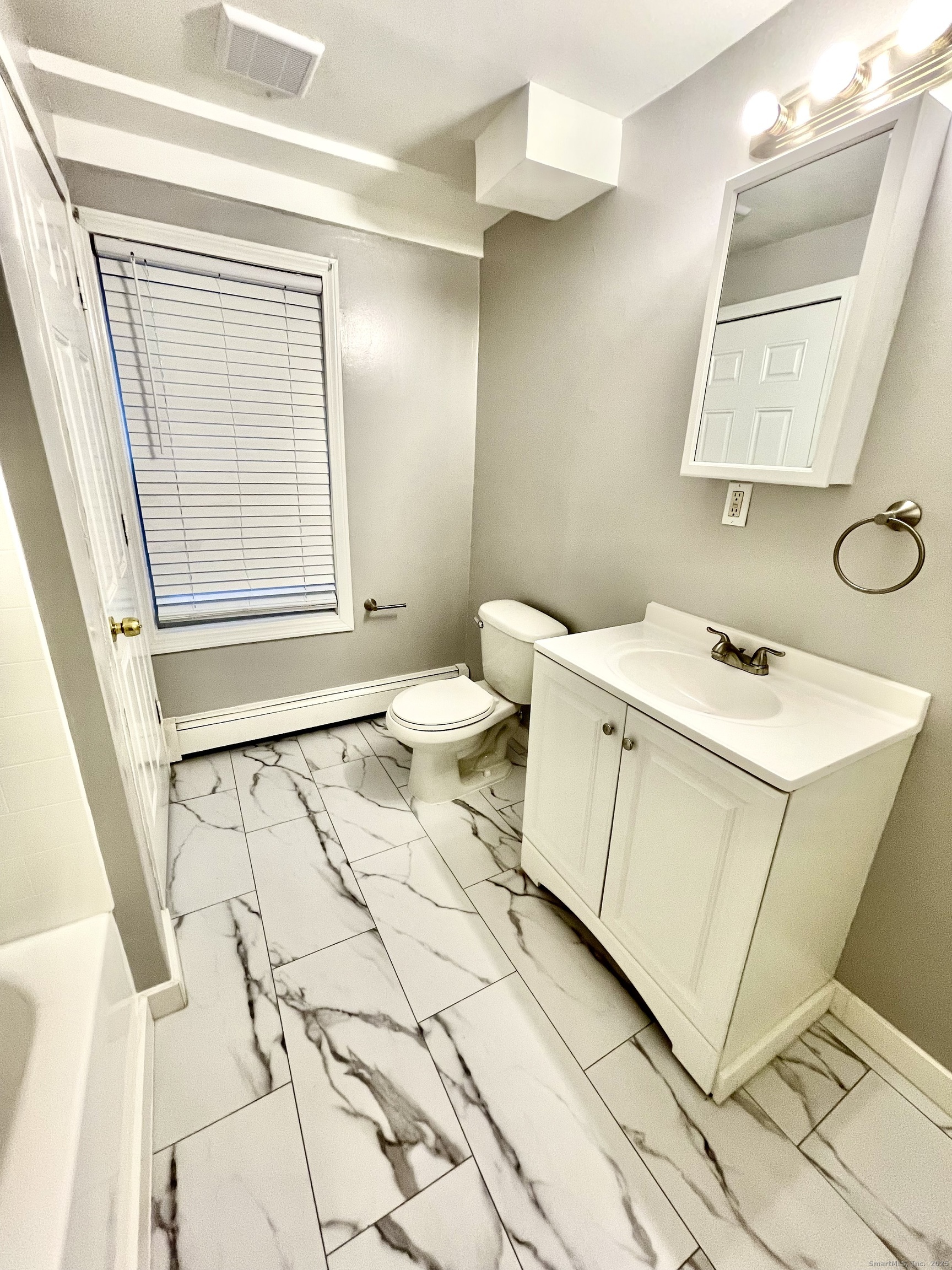 92 West Main Street, Unit 4 Vernon, CT 06066 - Photo 9 of 10 a bathroom with a sink toilet and vanity