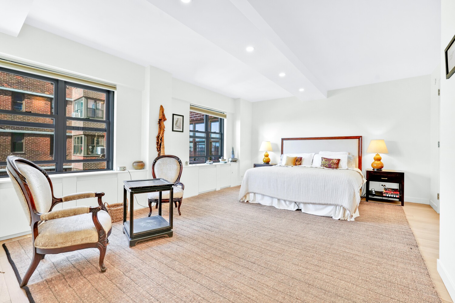 268 East Broadway, Unit A1706 Manhattan, NY 10002 - Photo 1 of 39 a bedroom with a bed and wooden floor