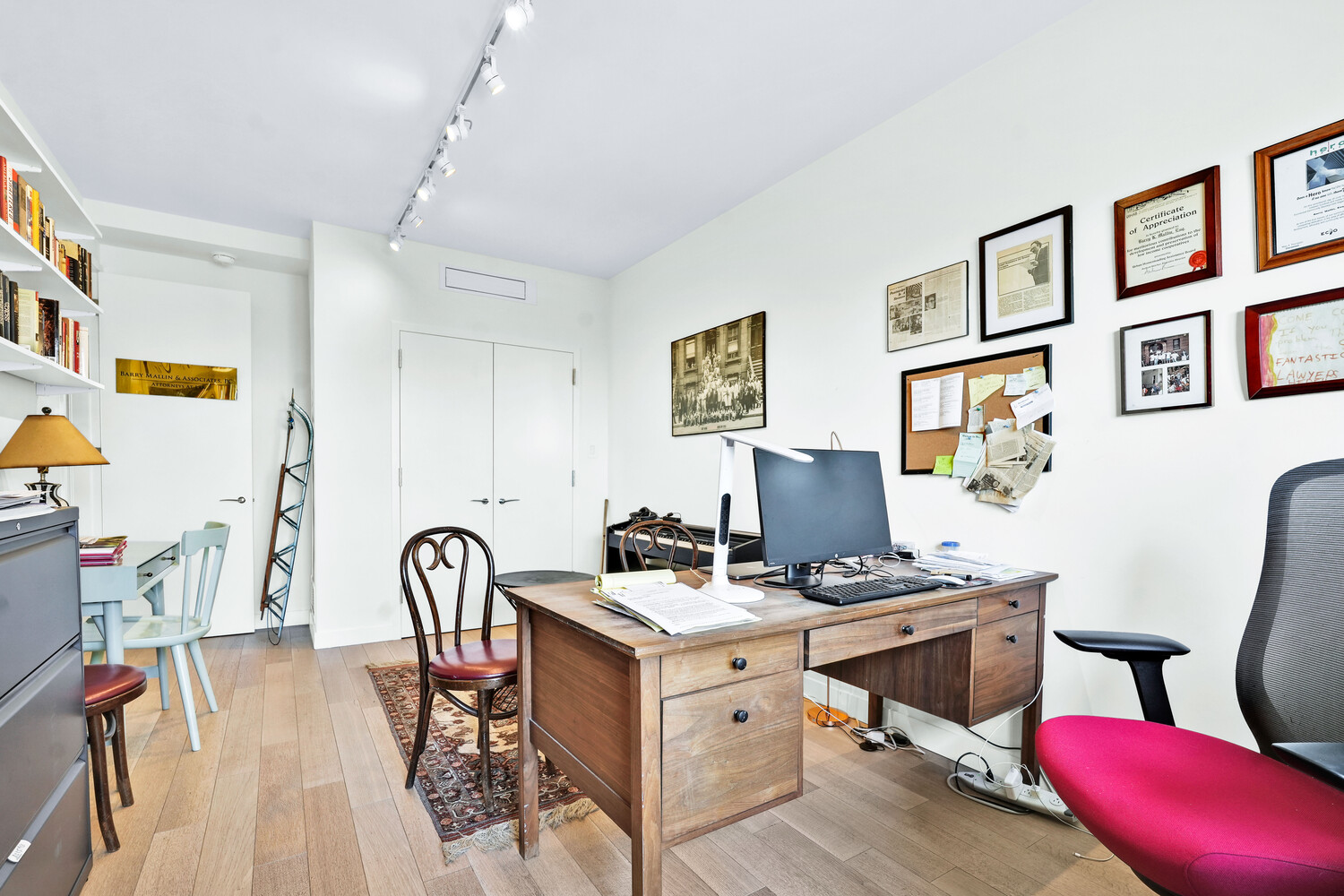 268 East Broadway, Unit A1706 Manhattan, NY 10002 - Photo 15 of 39 a workspace with wooden floor and furniture
