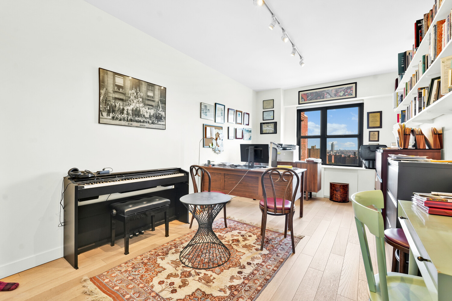 268 East Broadway, Unit A1706 Manhattan, NY 10002 - Photo 16 of 39 a living room with furniture piano and a bookshelf