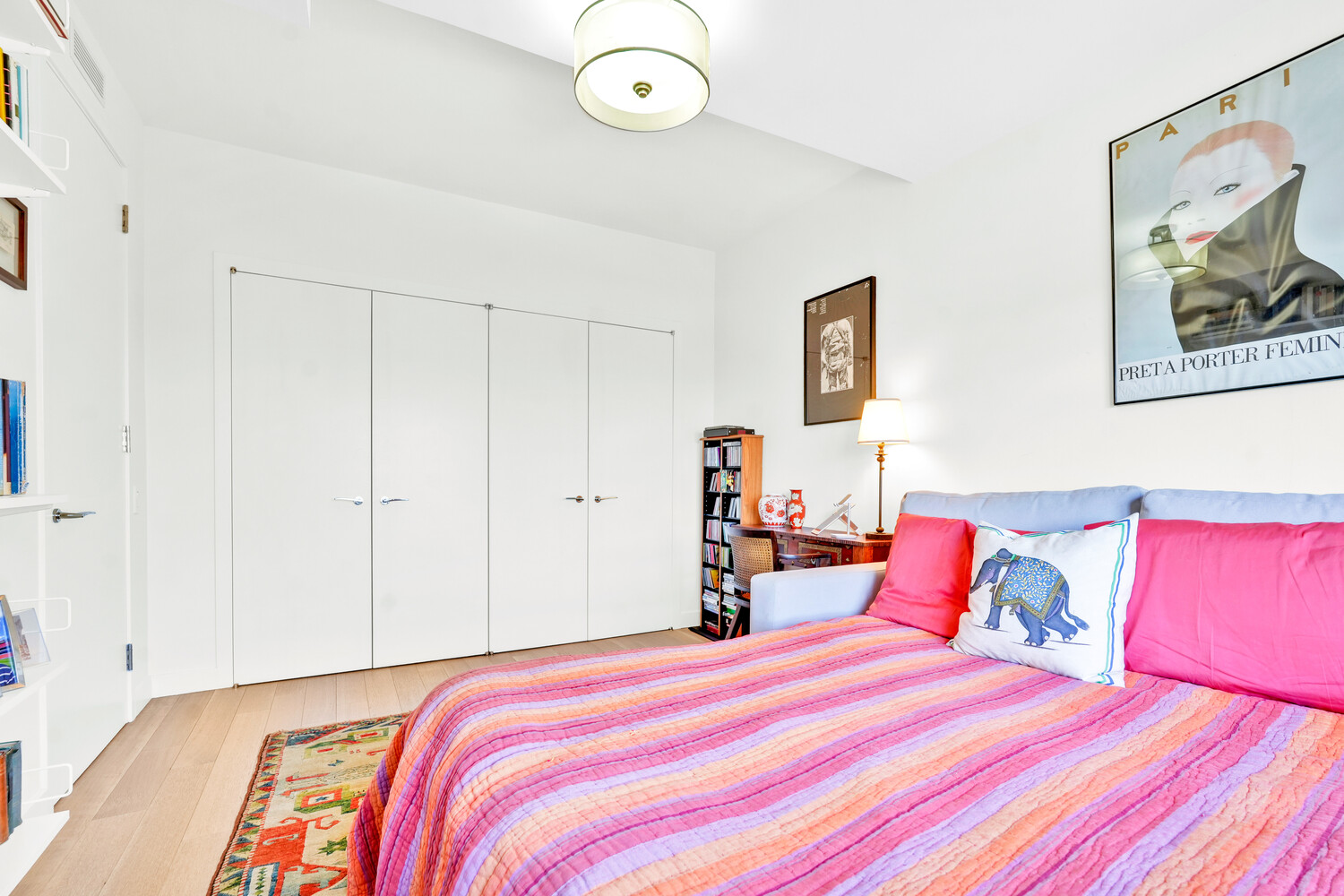 268 East Broadway, Unit A1706 Manhattan, NY 10002 - Photo 23 of 39 a bedroom with a bed and a painting on the wall