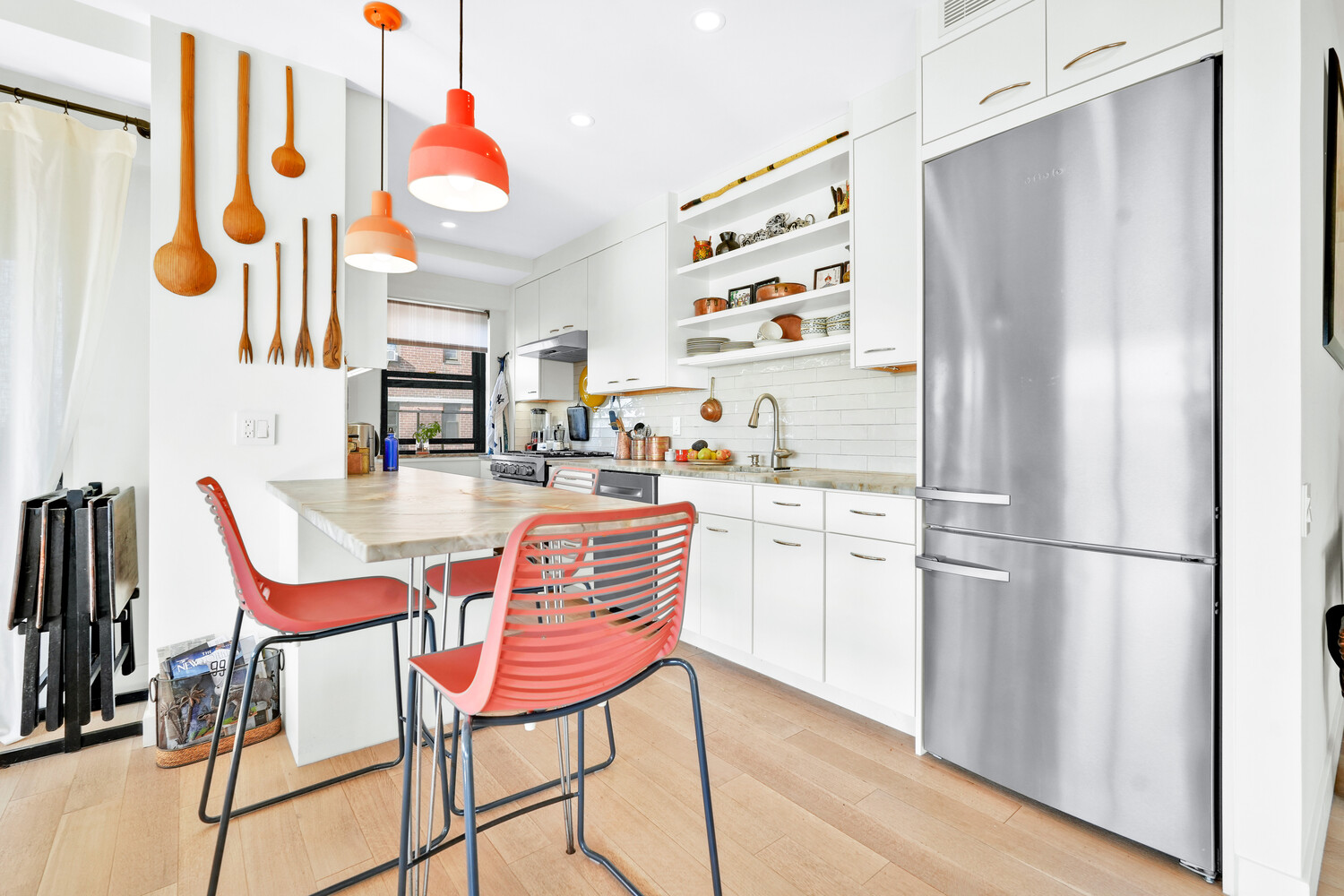 268 East Broadway, Unit A1706 Manhattan, NY 10002 - Photo 27 of 39 a room with stainless steel appliances kitchen island granite countertop furniture and a refrigerator