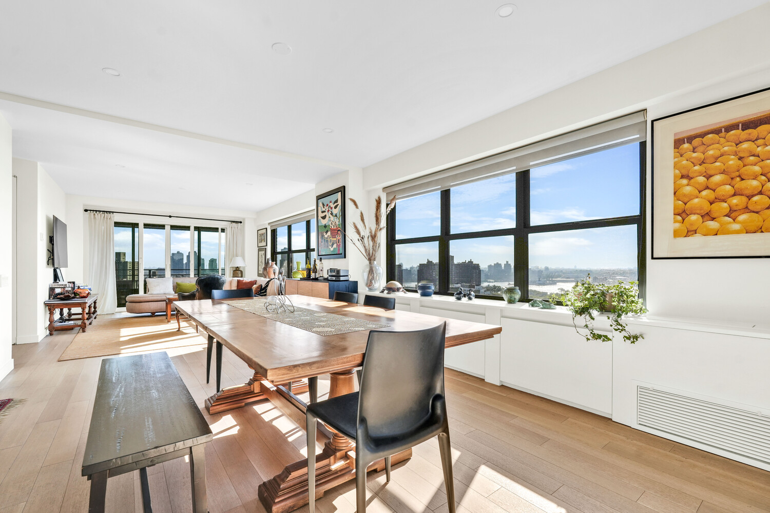 268 East Broadway, Unit A1706 Manhattan, NY 10002 - Photo 32 of 39 a dining room with furniture and a large window