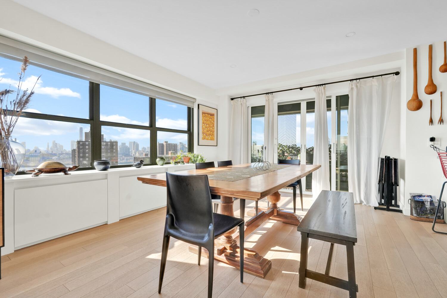 268 East Broadway, Unit A1706 Manhattan, NY 10002 - Photo 34 of 39 a view of a dining room with furniture window and wooden floor