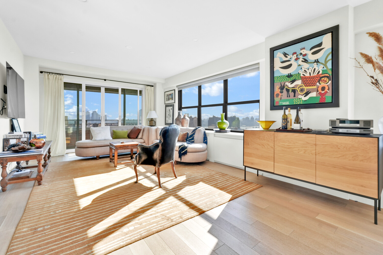 268 East Broadway, Unit A1706 Manhattan, NY 10002 - Photo 38 of 39 a living room with furniture a rug and a floor to ceiling window