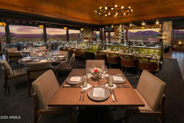 a view of a dining room with furniture and chandelier