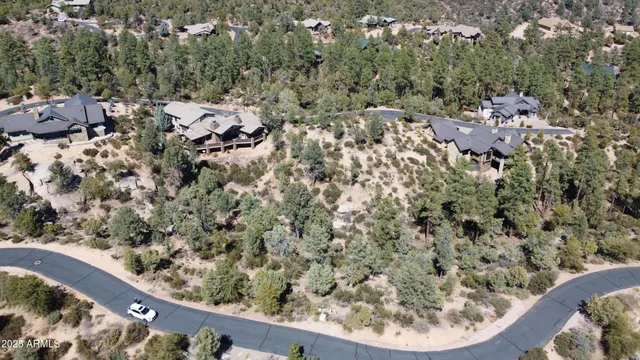 an aerial view of a house with a yard and mountain