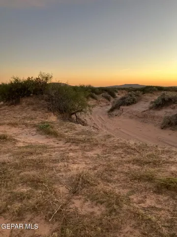 a view of a large mountain with mountains in the background