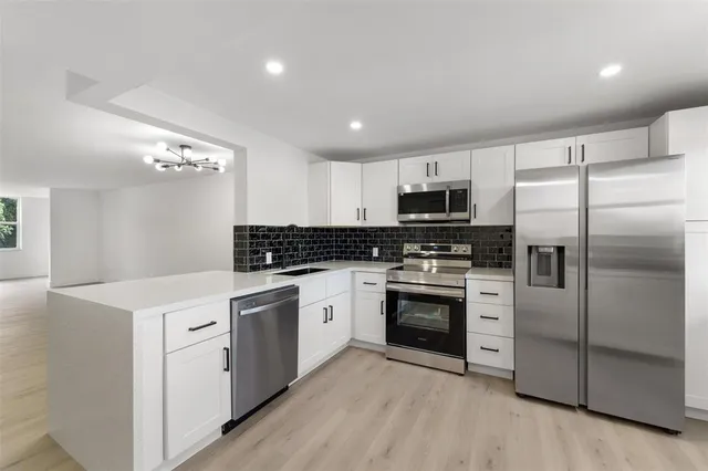 a kitchen with a refrigerator stove and microwave
