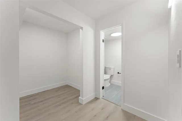 a bathroom with a granite countertop toilet and a shower