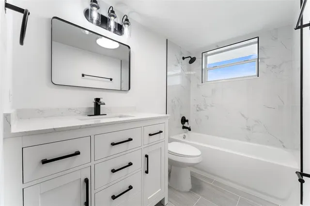 a bathroom with a toilet sink and bathtub