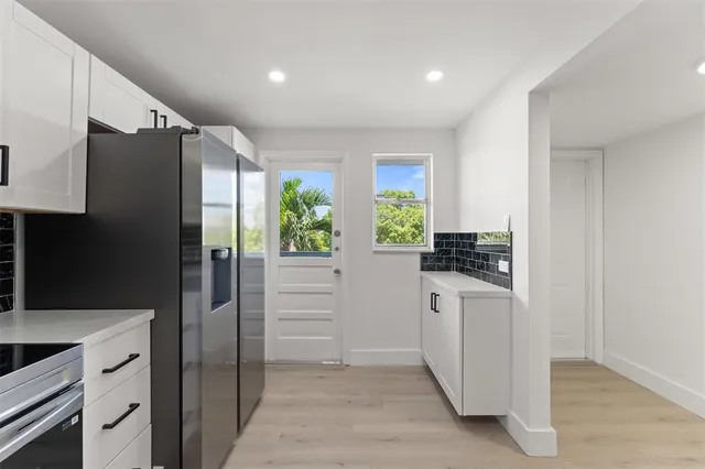 a kitchen with stainless steel appliances a refrigerator sink and stove
