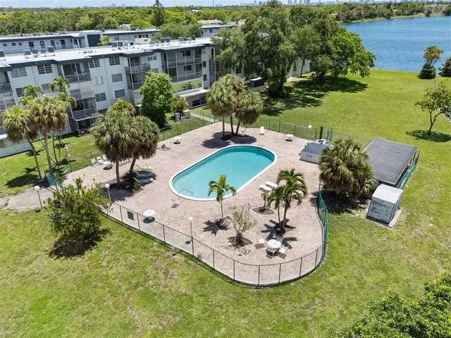 an aerial view of a city with lots of residential buildings ocean and mountain view in back