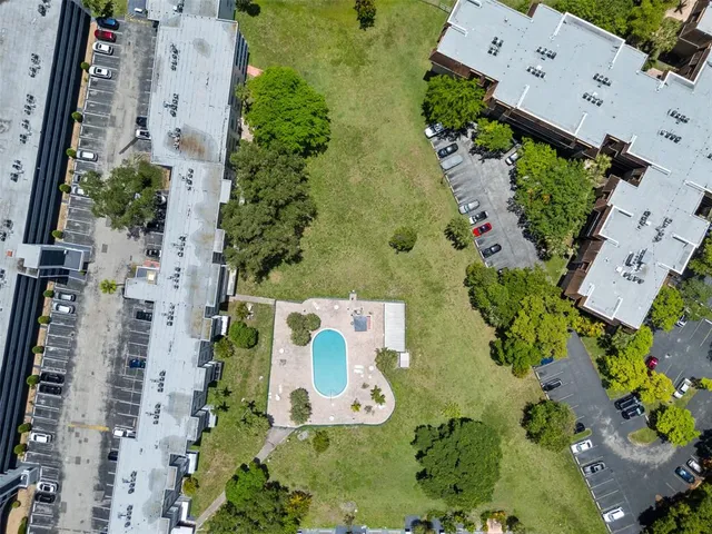 an aerial view of a city with lots of residential buildings ocean and mountain view in back