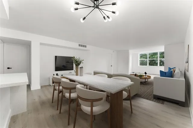 a view of a dining room with furniture and a window