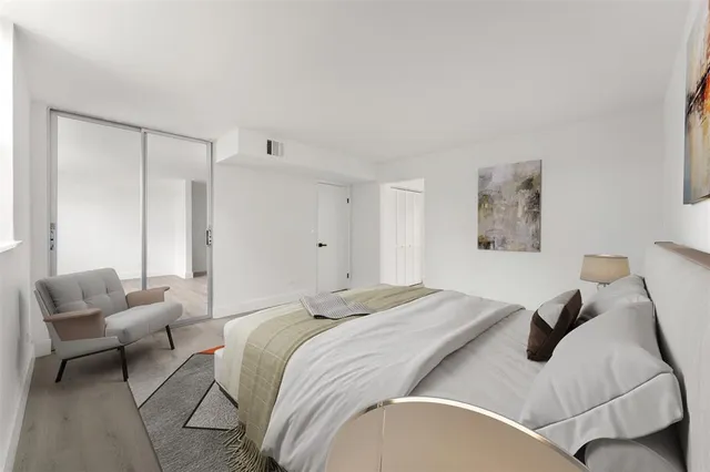 a bedroom with a bed and glass window